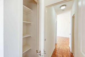 large linen closet and view of hallway at clarence house apartments in washington dc