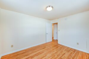bedroom with wood flooring at manor village apartments in washington dc