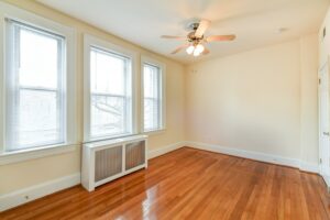 vacant bedroom with hardwood flooring, large windows and ceiling fan at the norwood apartments in washington dc