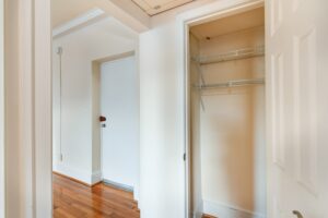 bedroom closet with shelving and view of front entrance at the norwood apartments in washington dc