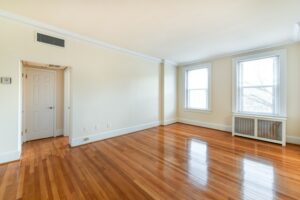 vacant living area with hardwood floors and large windows at the norwood apartments in washington dc