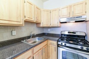 kitchen with stainless steel appliances, gas range and tile backsplash at the norwood apartments in washington dc