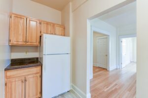 kitchen with refrigerator and view of hallway at twin oaks apartments in petworth washington dc