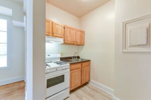 kitchen with gas range and tile backsplash at twin oaks apartments in petworth washington dc