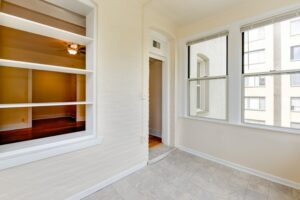 sunroom with exposed brick wall and large windows at twin oaks apartments in petworth washington dc