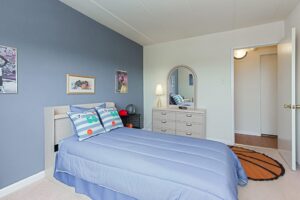 childrens bedroom with bed, dresser and mirror at washington view apartments in washington dc