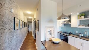 kitchen with stainless steel appliances, gooseneck faucet, tile backsplash and breakfast bar at avec on h luxury apartments in washington dc