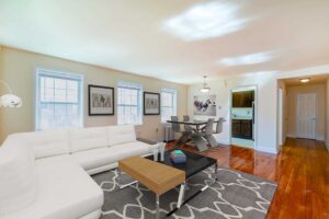 living area with sofa, coffee table, view of dining area and kitchen at hillside terrace apartments in washington dc