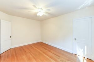 vacant bedroom with wood floors and ceiling fan at 4031 davis place apartments in glover park washington dc