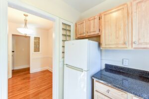 kitchen with fridge and wood cabinets at 4031 davis place apartments in glover park washington dc