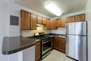 kitchen with stainless steel appliances and breakfast bar at hilltop house apartments in columbia heights washington dc