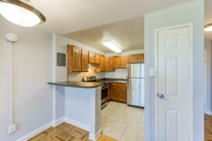 kitchen with breakfast bar, stainless steel appliances, and pantry at hilltop house apartments in columbia heights washington dc