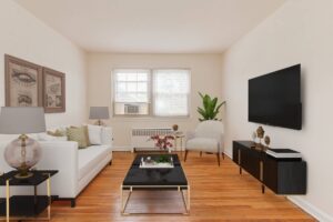 living area with sofa, coffee table, tv, credenza and hardwood floors at penn view apartments in washington dc