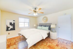 bedroom with ceiling fan and wood floors at new horizon apartments in skyland washington dc