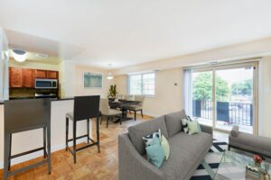 open layout of apartment showing living area, dining area and kitchen with breakfast bar at naylor overlook apartments in se washington dc