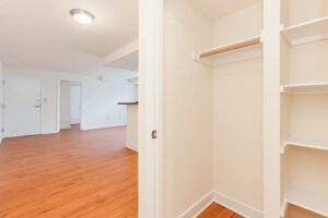 hallway view of closet with built in shelving and view of living area at t street apartments in washington dc