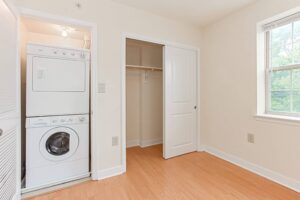 laundry area with stackable washer and dryer at the oaks apartments in washington dc