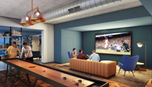 resident lounge with shuffle board table, social seating, and large tv at the garrett apartments at the collective in washington dc