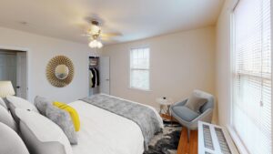 bedroom with bed, nightstand, closet, hardwood floors and ceiling fan at 6100 14th street apartments in brightwood washington dc