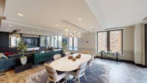 club room with social seating, tv and communal dining table at avec on h luxury apartments in washington dc