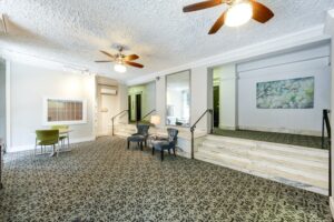 lobby lounge with social seating, ceiling fan and stars to apartments at hampton courts apartments in washington dc