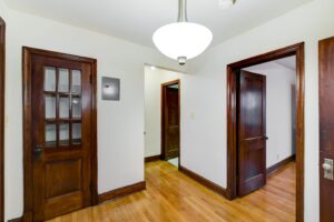 hallway view of front entrance and living area with dark doorway accent at 2629 39th Street apartments in washington dc