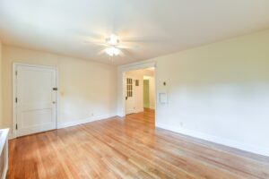 vacant living area with hardwood floors, ceiling fan and ceiling fan at 2629 39th Street apartments in washington dc