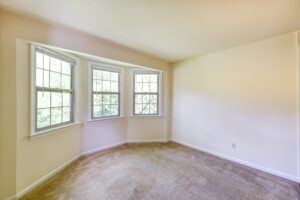 vacant sun room with large windows and carpeting at 2629 39th Street apartments in washington dc