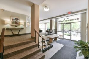 lobby lounge with social seating, office and large windows at brunswick house apartments in dupont circle washington dc