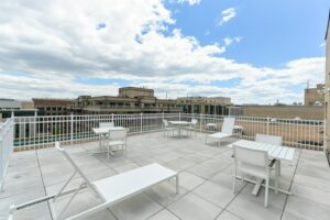 rooftop lounge with social seating, tables and view of washington dc at brunswick house apartments in dupont circle washington dc