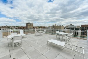 rooftop lounge with social seating, tables and view of washington dc at brunswick house apartments in dupont circle washington dc