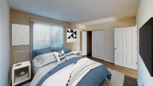 bedroom with bed, nightstands, closet, tv and wood floors at city towns apartments in washington dc