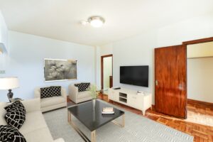 living area with sofa, coffee table, large closet, tv and credenza at the eddystone apartments in washington dc
