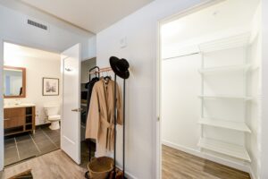 bedroom with large closet and view of bathroom at the garrett apartments at the collective in washington dc