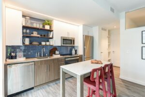 kitchen with stainless steel appliances, kitchen island and hardwood floors at the garrett apartments at the collective in washington dc