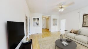 living area with sofa, coffee table, hardwood floors, ceiling fan and view of front entrance at the calverton apartments in adams morgan washington dc