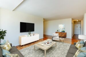 living area with sofa, coffee table, tv, credenza, hardwood floors and view of front entrance at brunswick house apartments in dupont circle washington dc