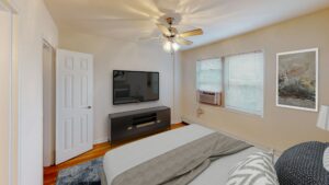bedroom with wood floors and ceiling fan at alpha house apartments in columbia heights washington dc