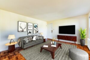 living area with sofa, coffee table, credenza tv, wood floors and view of entrance at richman apartments in congress heights washington dc