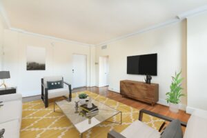 living area with sofa, coffee table, credenza, tv and view of front entrance at the norwood apartments in washington dc