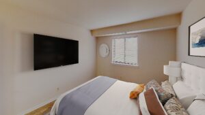 bedroom with bed, tv, night stand and window at washington view apartments in washington dc