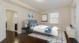 bedroom with wood floors and large windows at juniper courts tax credit apartments in takoma washington dc