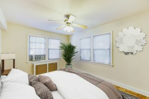 bedroom with hardwood floors, windows and ceiling fan at meridian park apartments in columbia heights nw washington dc