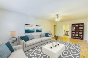 living area with sofa, coffee table, hardwood floors, ceiling fan and view of dining area at meridian park apartments in columbia heights nw washington dc