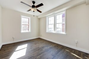 vacant bedroom with ceiling fan and large windows at petworth station apartments in washington dc