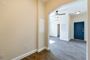 hallway view of living area and front entrance with wood floors and ceiling fan at petworth station apartments in washington dc