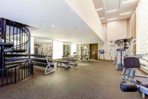 fitness center with free weights, strength training machines and exercise balls at crest at skyland apartments in washington dc