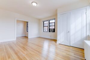vacant bedroom with wood floors and large windows at the dahlia apartments in washington dc