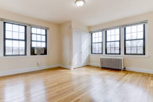 vacant living area with wood floors and large windows at the dahlia apartments in washington dc
