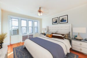 bedroom with bed, nightstands, large windows and hardwood flooring at chatham courts apartments in adams morgan washington dc